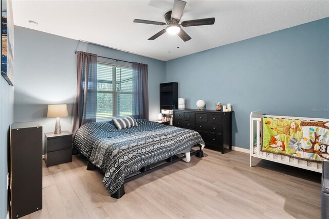 bedroom with ceiling fan and light hardwood / wood-style flooring