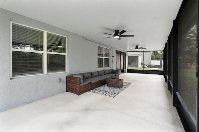 sunroom / solarium featuring ceiling fan