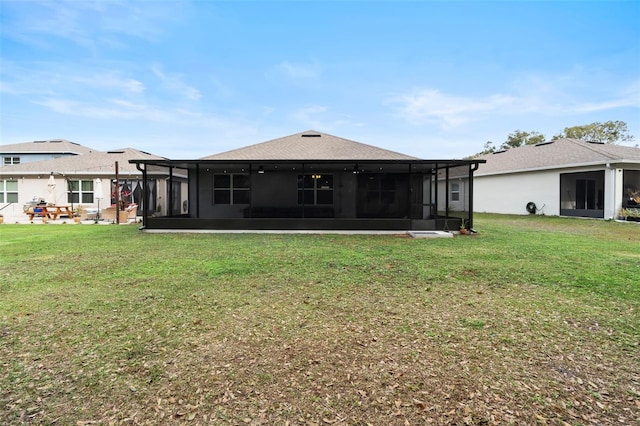 3627 Crimson Clover Dr, Mount Dora, FL 32757 - back of house featuring a shingled roof, a sunroom, and a yard