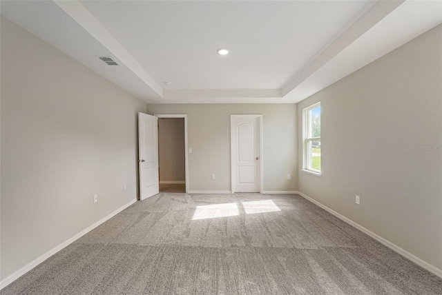 25122 Ensley Rd, Sorrento, FL 32776 - unfurnished bedroom featuring a raised ceiling, light carpet, and recessed lighting