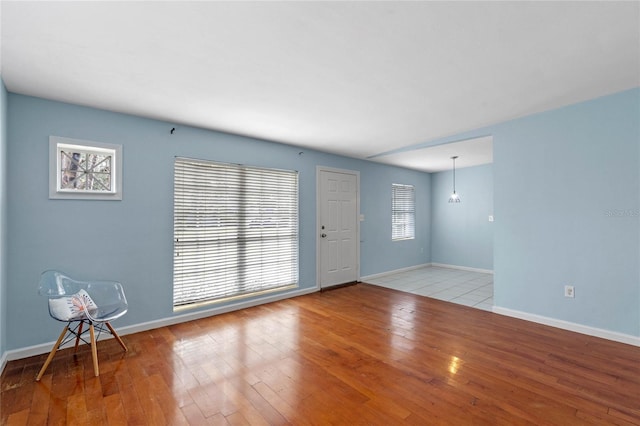 empty room with light wood-type flooring and a healthy amount of sunlight