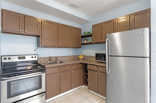 kitchen featuring light tile patterned floors, sink, and appliances with stainless steel finishes