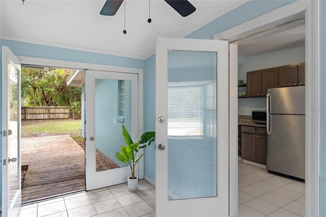 doorway with ceiling fan, french doors, and light tile patterned flooring