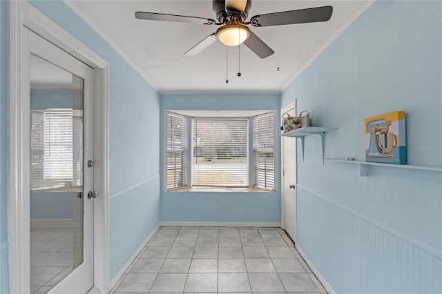 doorway to outside featuring ceiling fan, light tile patterned floors, and crown molding