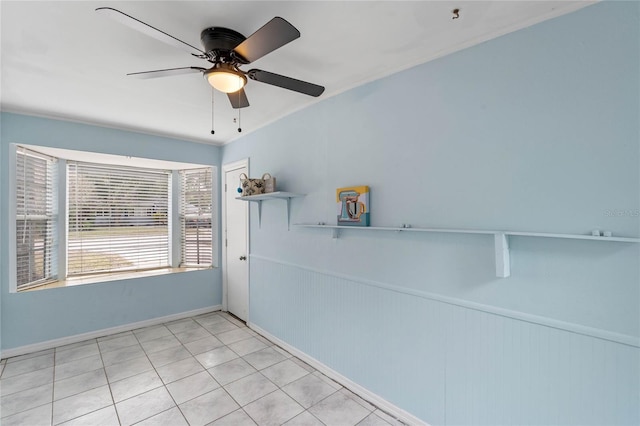 tiled spare room featuring ceiling fan