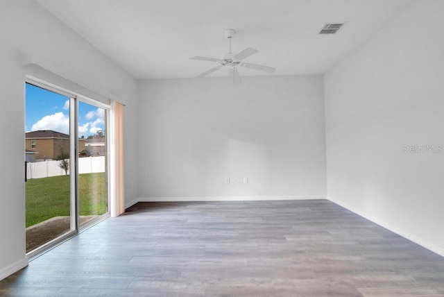 unfurnished room with ceiling fan and hardwood / wood-style floors