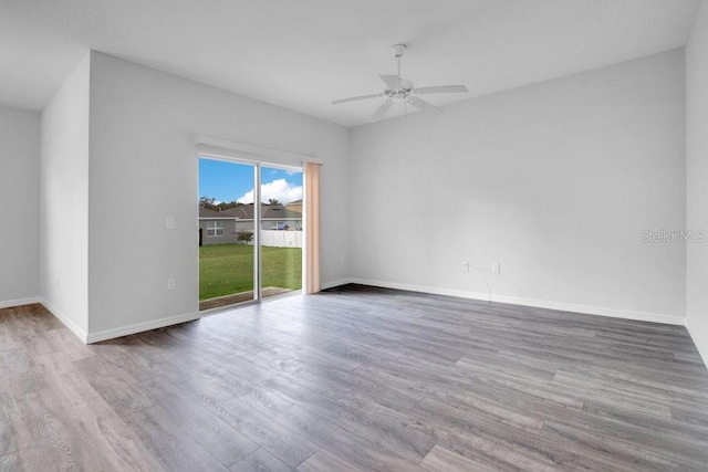 empty room featuring ceiling fan and light hardwood / wood-style flooring