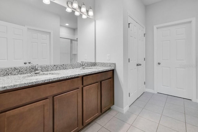 bathroom featuring an enclosed shower, vanity, and tile patterned flooring