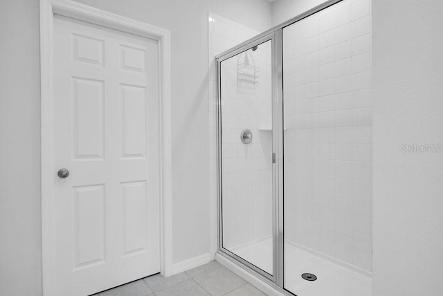 bathroom featuring tile patterned flooring and an enclosed shower