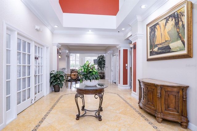 hallway with light tile patterned floors, ornate columns, and french doors