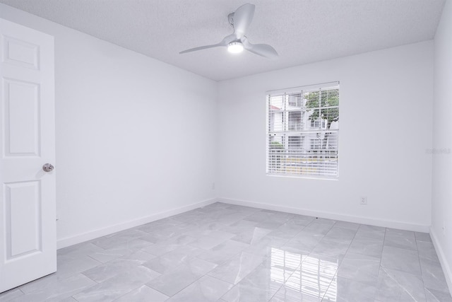 unfurnished room with a textured ceiling and ceiling fan