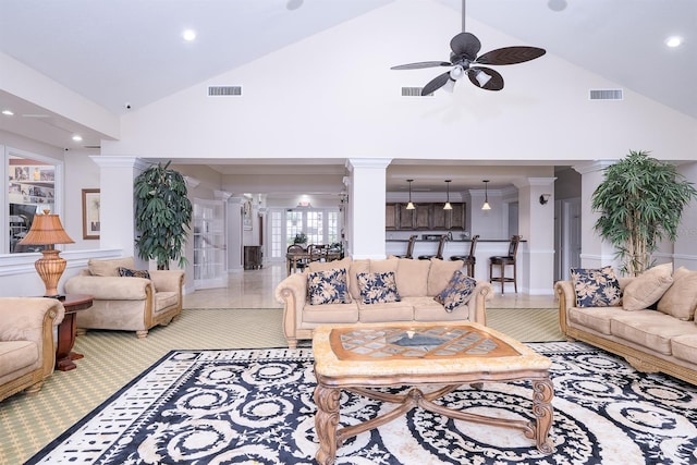 living room with ceiling fan, crown molding, high vaulted ceiling, and ornate columns