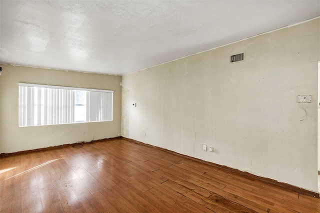 spare room featuring hardwood / wood-style floors