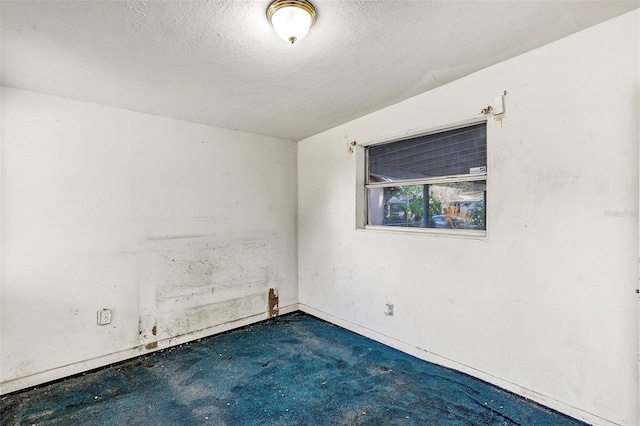 empty room with a textured ceiling