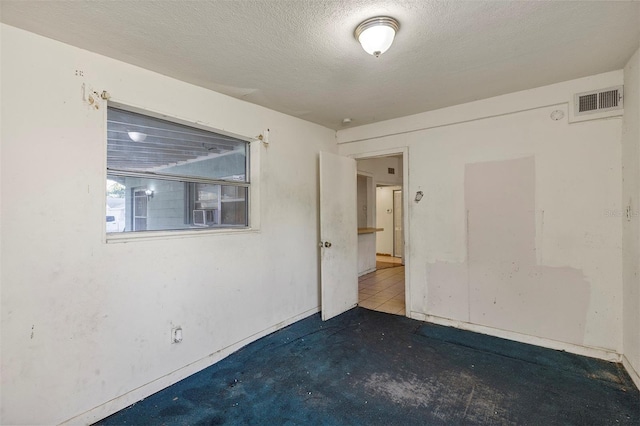 empty room with a textured ceiling