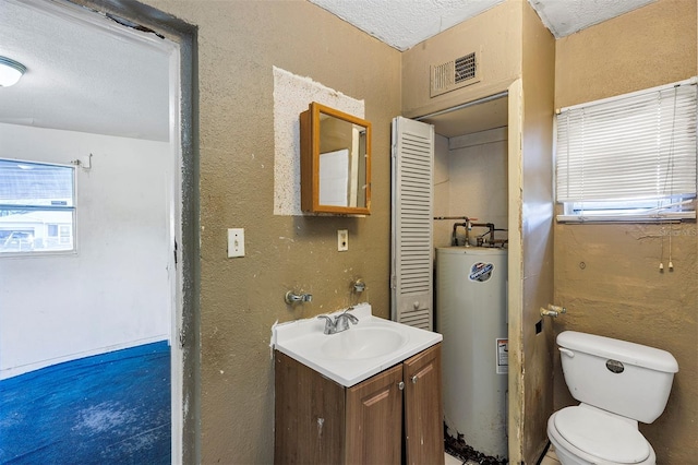 bathroom with water heater, toilet, a textured ceiling, and vanity