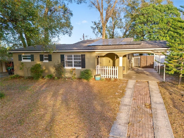 single story home with a carport, fence, and concrete driveway