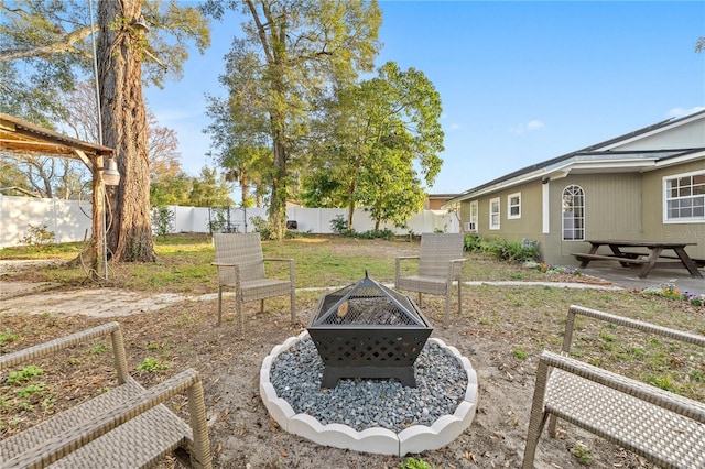 view of yard with an outdoor fire pit, a fenced backyard, and a patio