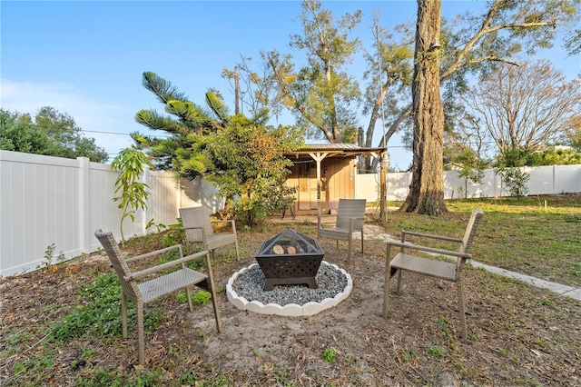 view of yard with an outdoor fire pit and a fenced backyard