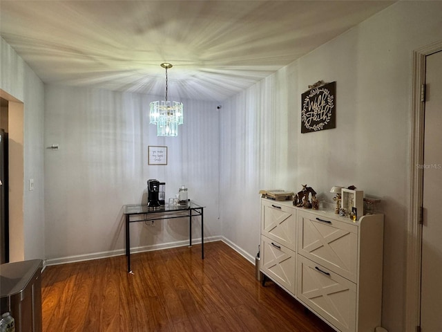 interior space featuring dark wood-type flooring and a notable chandelier