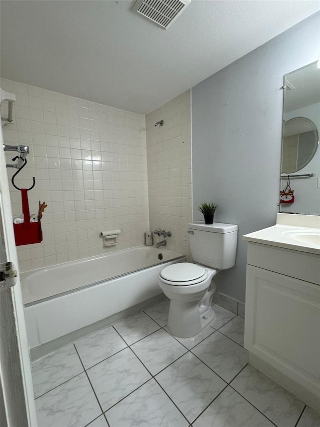 full bathroom featuring toilet, tiled shower / bath, and vanity