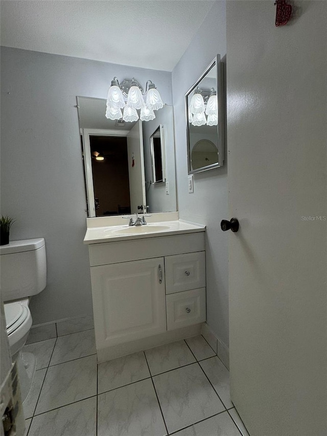 bathroom with toilet and vanity