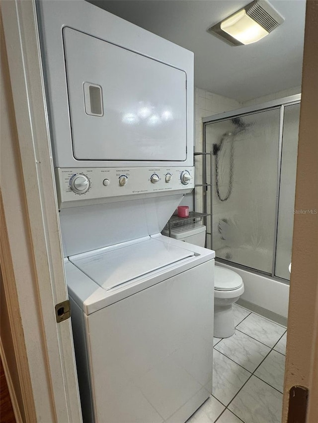 laundry area with stacked washer and clothes dryer