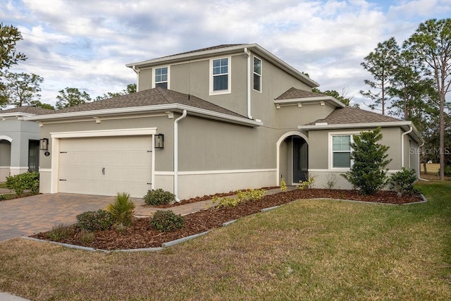 front of property featuring a front lawn and a garage