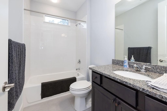 full bathroom featuring washtub / shower combination, toilet, tile patterned flooring, and vanity