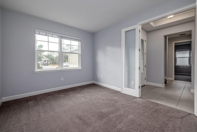 unfurnished room with light colored carpet