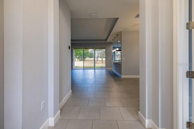 corridor featuring light tile patterned flooring