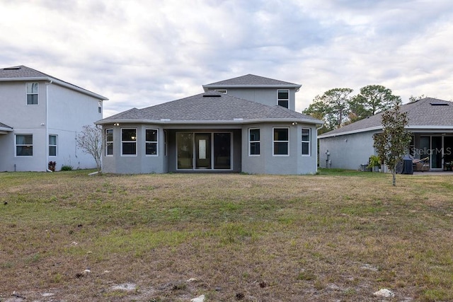 back of property with a lawn