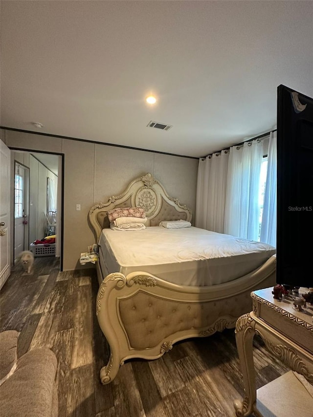 bedroom with dark wood-type flooring