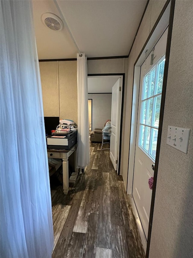 hall featuring dark hardwood / wood-style flooring and ornamental molding