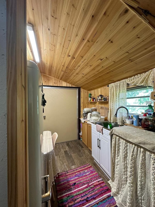 bathroom featuring sink, wood walls, vaulted ceiling, hardwood / wood-style flooring, and wooden ceiling