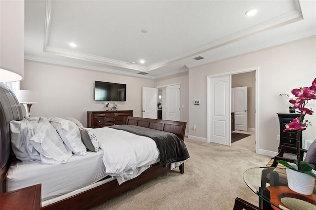 bedroom featuring light carpet, visible vents, baseboards, ornamental molding, and a raised ceiling