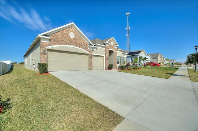 view of front of home featuring a garage, a front lawn, and concrete driveway