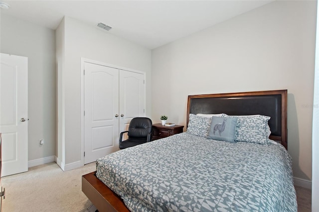 bedroom featuring a closet, baseboards, visible vents, and carpet flooring