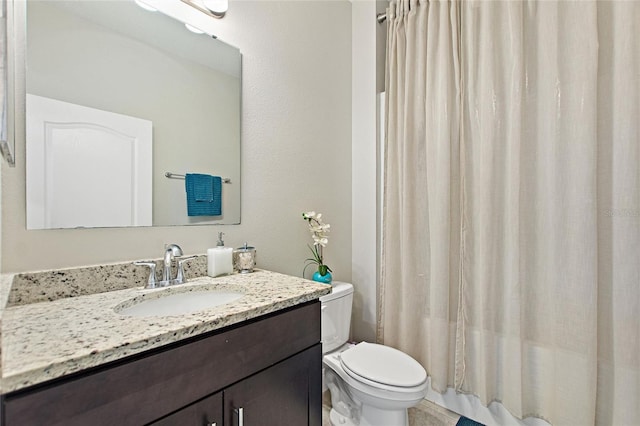 bathroom featuring toilet, curtained shower, and vanity