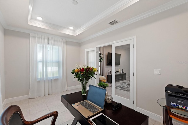 home office with a tray ceiling, light tile patterned floors, visible vents, ornamental molding, and baseboards