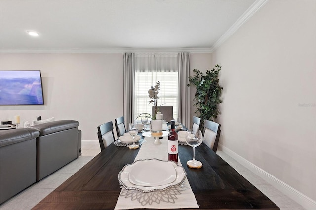 dining room with light tile patterned floors, baseboards, and crown molding