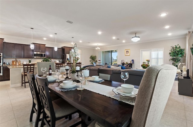 dining area with light tile patterned floors, ornamental molding, visible vents, and a healthy amount of sunlight