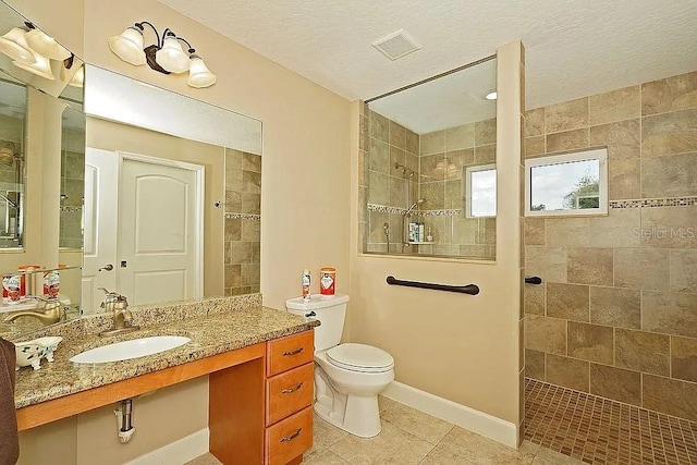 bathroom featuring tile patterned floors, visible vents, toilet, a walk in shower, and baseboards