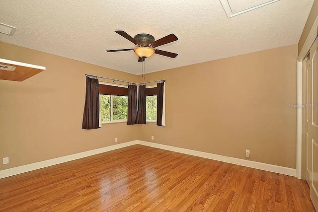 empty room with baseboards and light wood finished floors