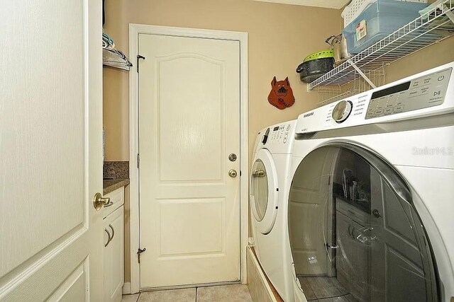 laundry area featuring independent washer and dryer, light tile patterned flooring, and laundry area