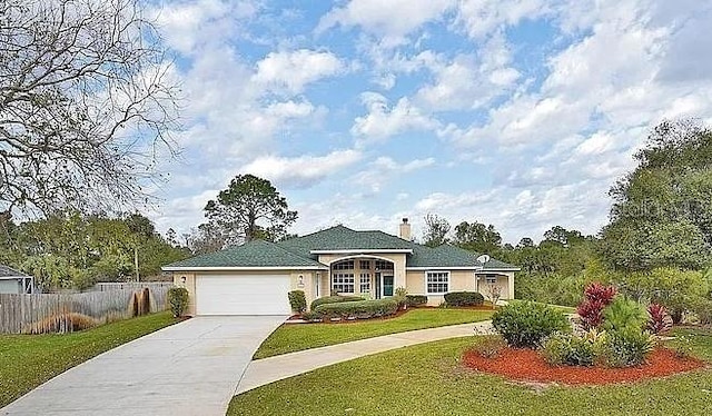 ranch-style house featuring fence, concrete driveway, a front yard, a chimney, and a garage