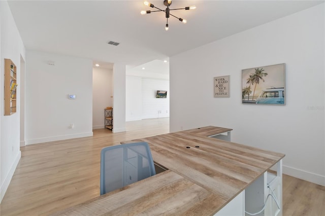 kitchen featuring wood-type flooring and a chandelier