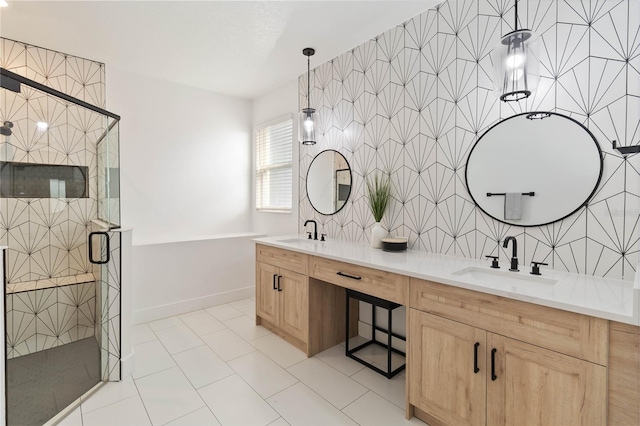 bathroom with tile patterned floors, vanity, and shower with separate bathtub