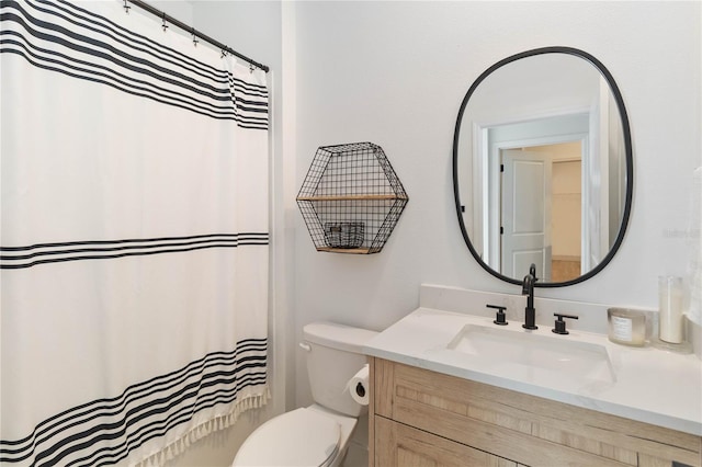 bathroom with toilet, vanity, and curtained shower