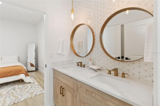 bathroom featuring vanity, wood-type flooring, and backsplash